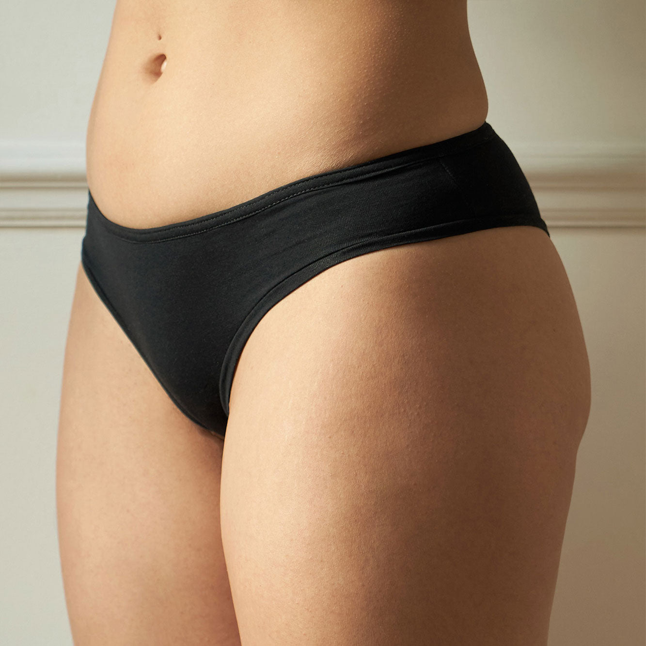 Black Organic & Recycled cotton Cheeky Fit Briefs on a female figure, back facing