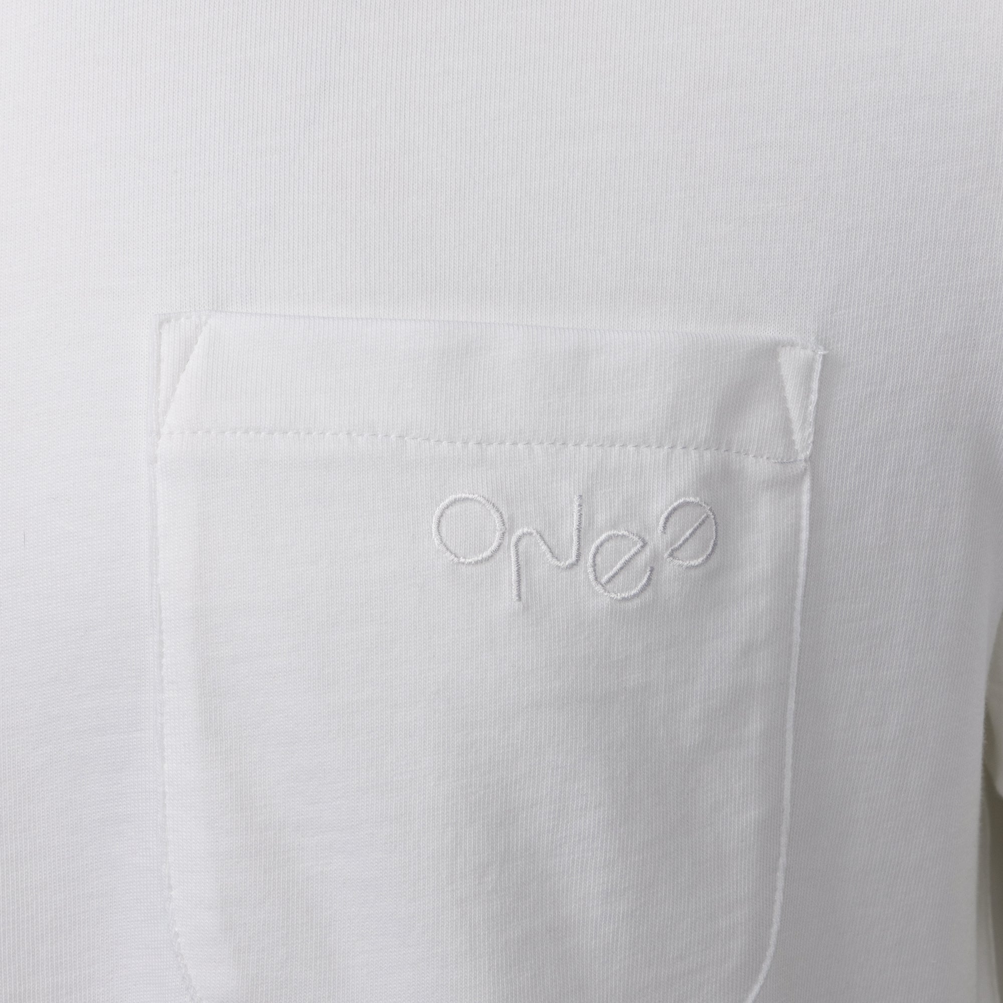 Organic cotton white t shirt detail from ONE Essentials. Organic and recycled cotton pocket t shirt